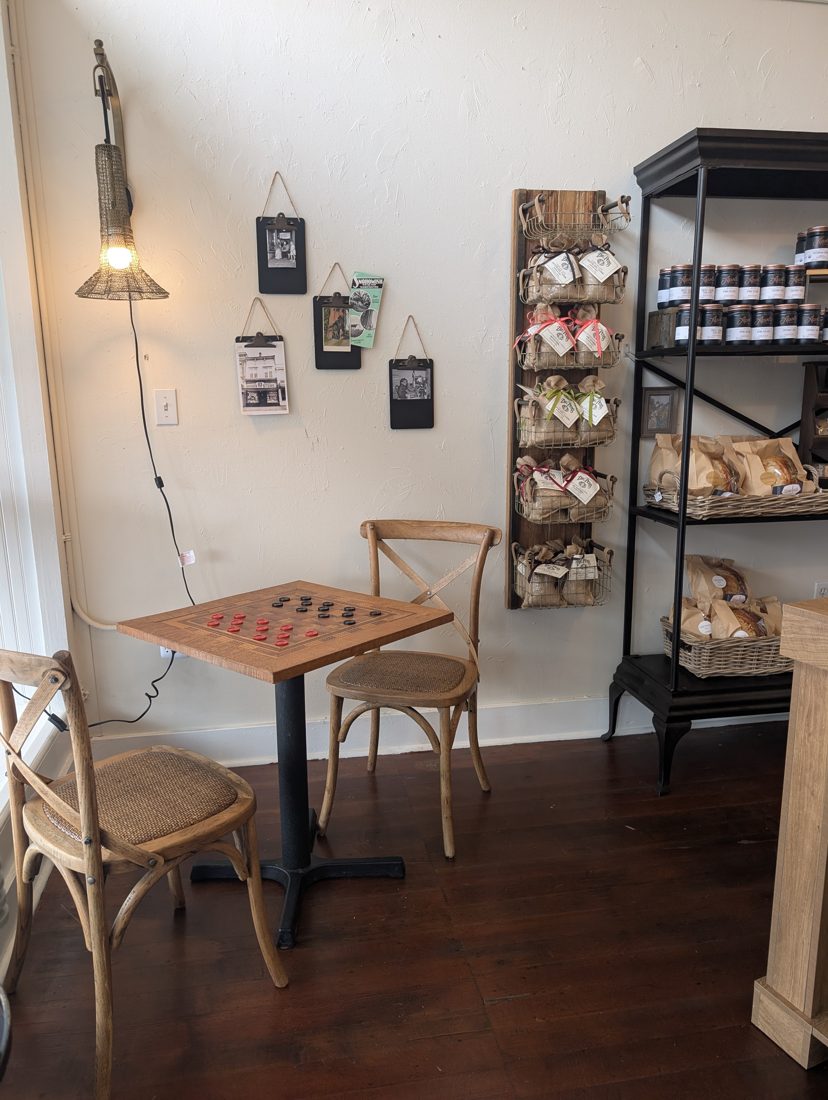 A checkers table by the window and shelves of local goods inside Snohomish General Store